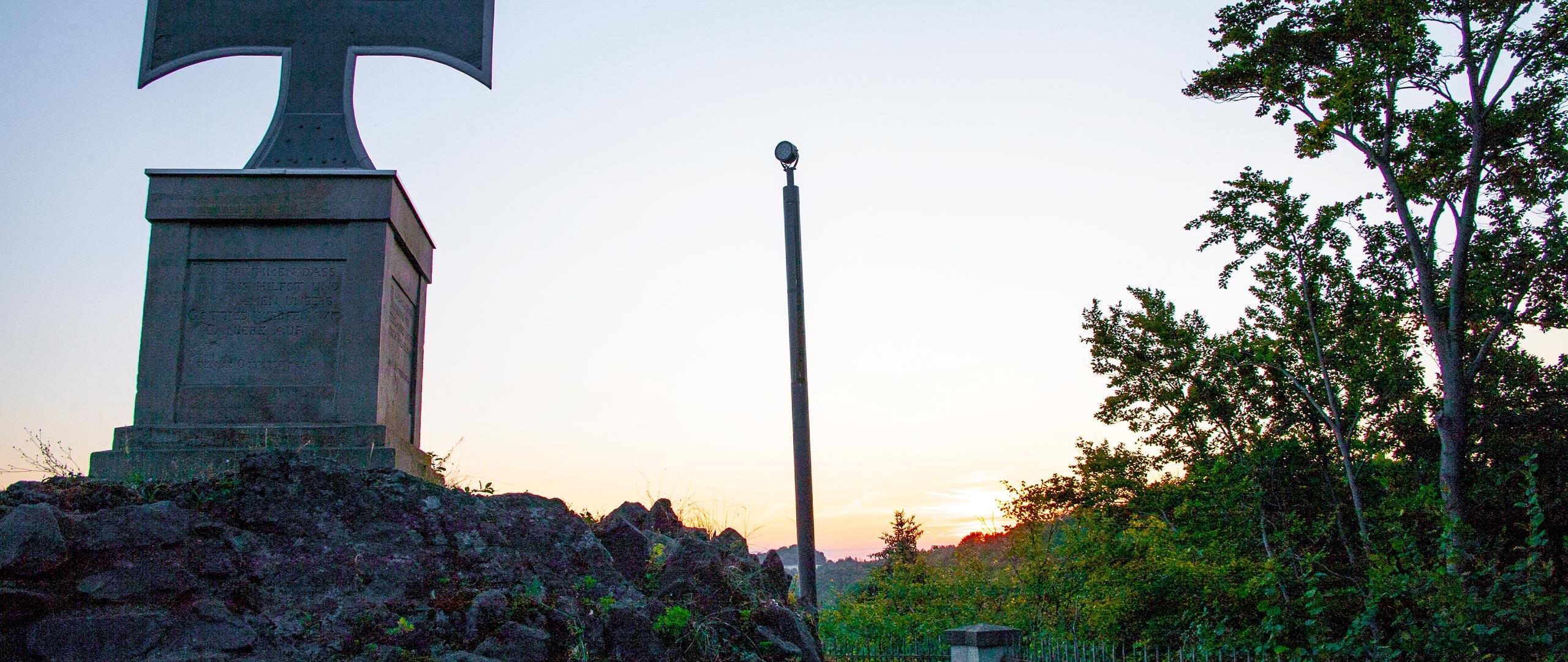Solar-powered monument lighting pole at sunset